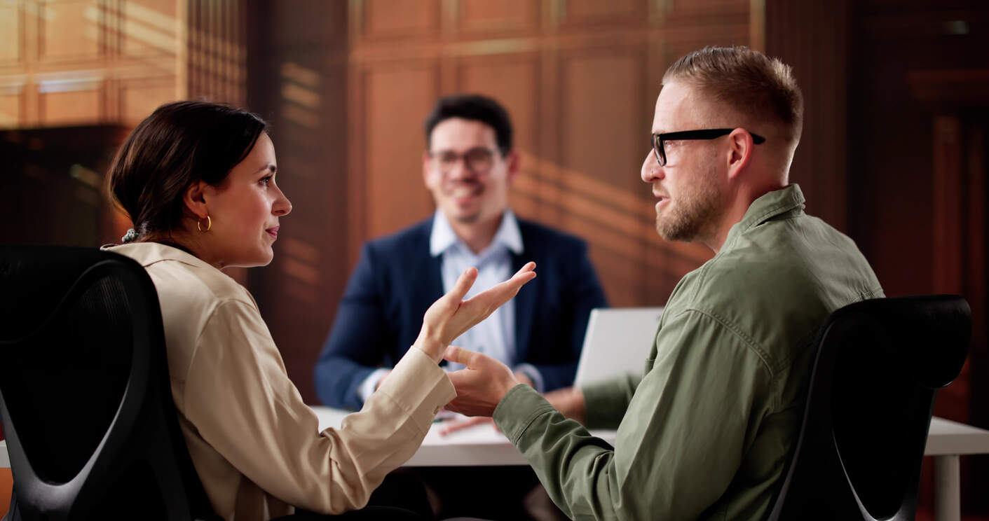 A couple talking with a male mediator, representing family law mediation services in Orange County.