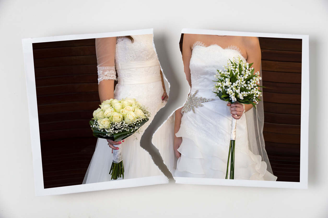 Same-sex marriage in white wedding dresses holding bouquets, symbolizing separation or conflict